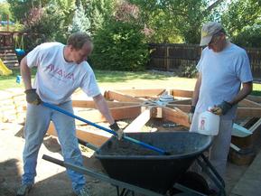 Hand mixing the concrete.