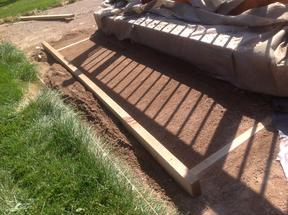 Shoveling out excess crusher fine base for flagstone patio.