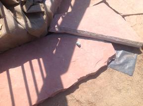 Chalking the cut line onto the flagstone.