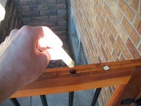 Inserting baluster plugs in gate.