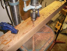 View of baluster and screw holes being drilled in top rail.